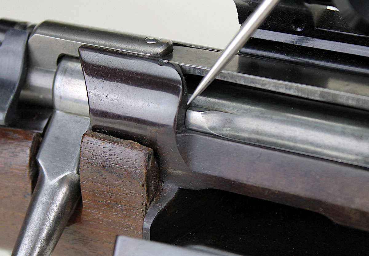 On Danish and Norwegian Krags, the guide rib serves as a second locking lug by engaging the receiver wall when the bolt is closed. On US military Krags, there is a gap between the guide rib and receiver, so the guide rib acts only as a backup in case of bolt locking lug failure. As shown here, careful honing and lapping of the US Krag locking lug will permit the guide rib to engage the receiver to become a second locking lug. The barrel must then be set back to restore proper headspace.